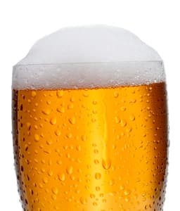 a glass of foamy beer