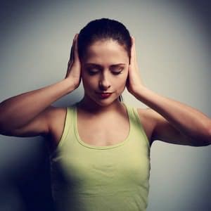 Woman in distress covering her ears