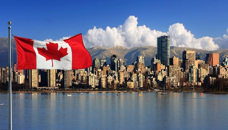 Canadian flag in front of the beautiful city of Vancouver, Canada.
