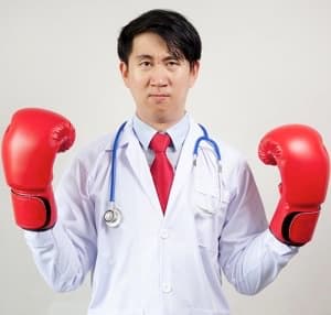 Doctor wearing boxing gloves ready for a fight