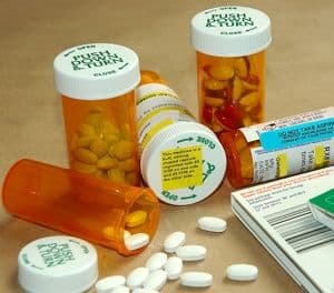 bottles of medications with warning stickers and information