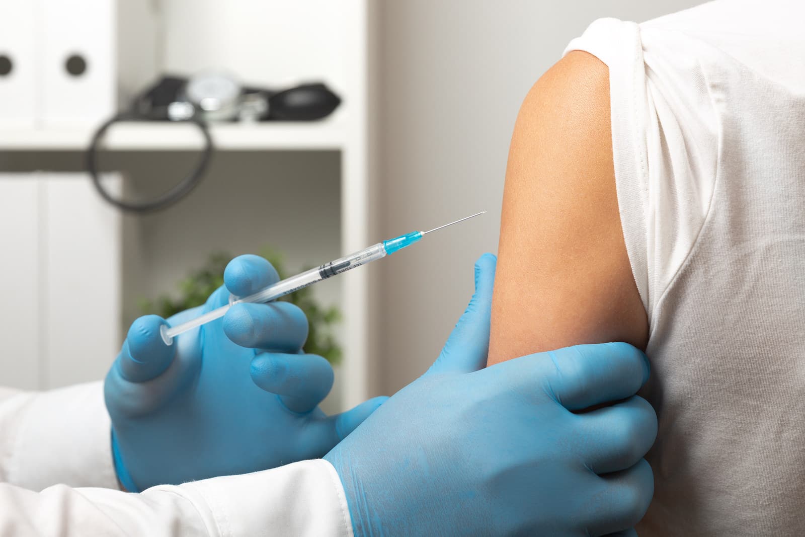 Doctor prepares to give a flu shot or COVID-19 vaccine with proper injection technique