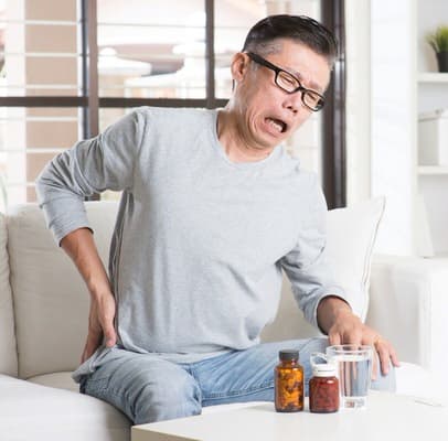 Man with pain around kidneys or back holding his side