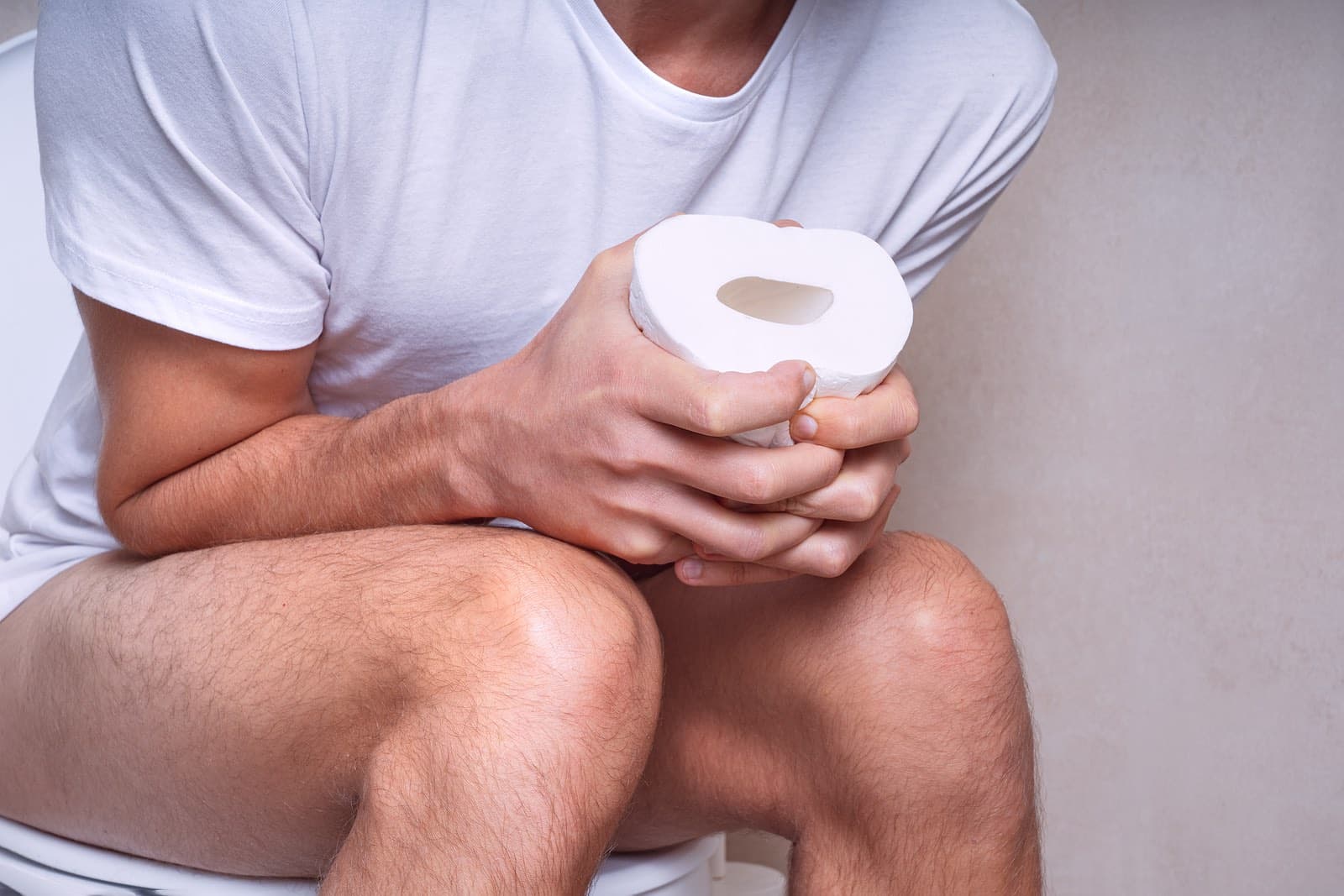man sitting on toilet with diarrhea