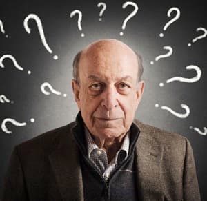 Old man confused with many question marks
