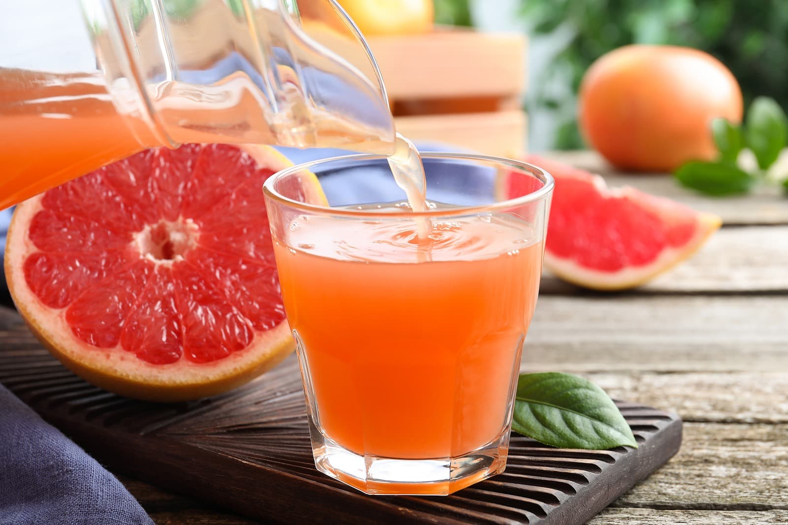 pouring grapefruit juice into a glass