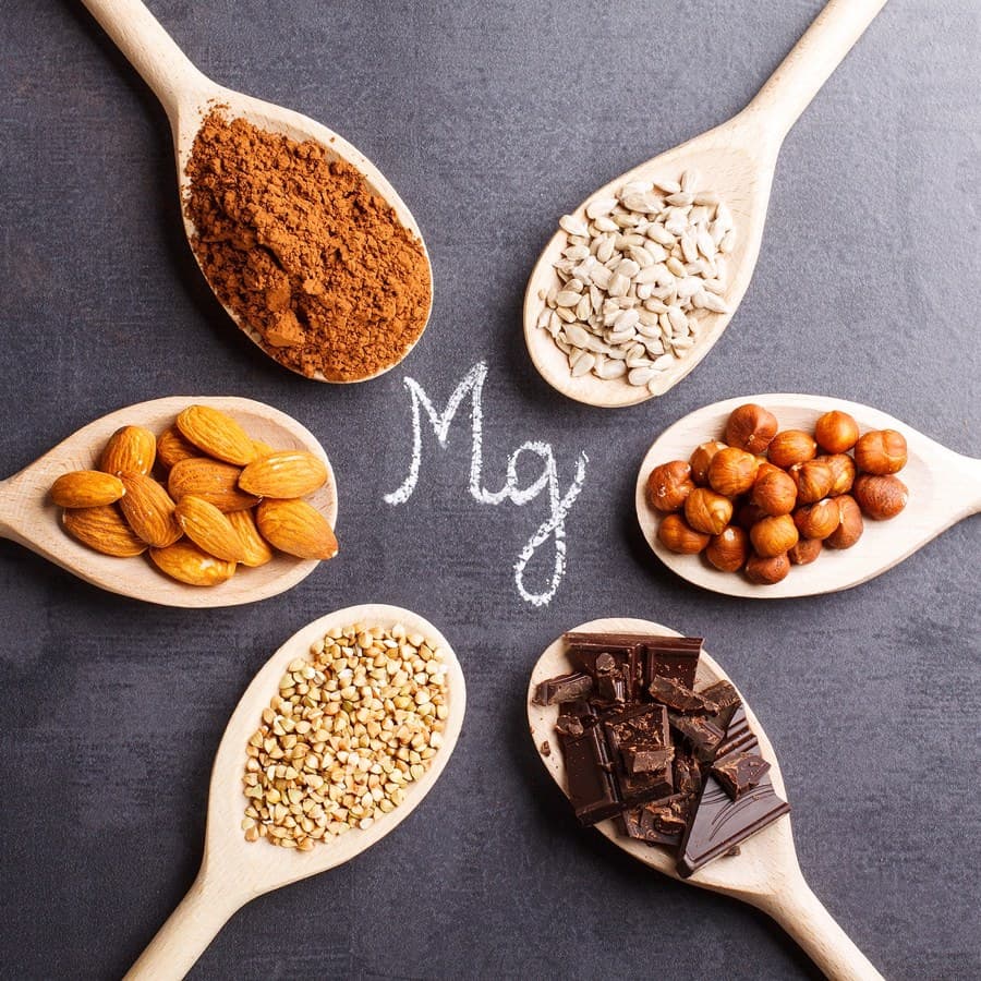 Products rich in magnesium on wooden spoons.
