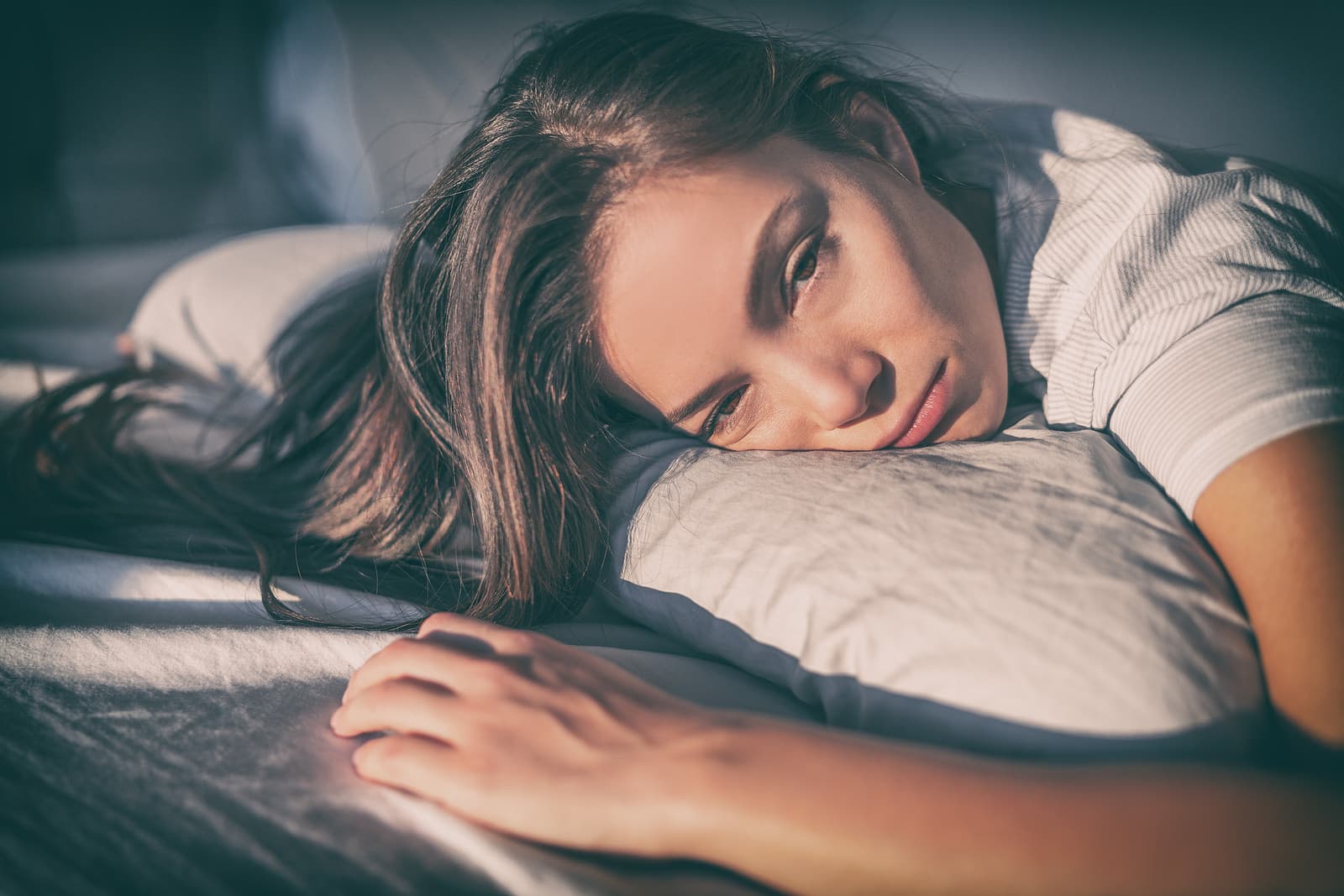 COVID-19 long hauler Woman in bed with fatigue feels bad after COVID-19