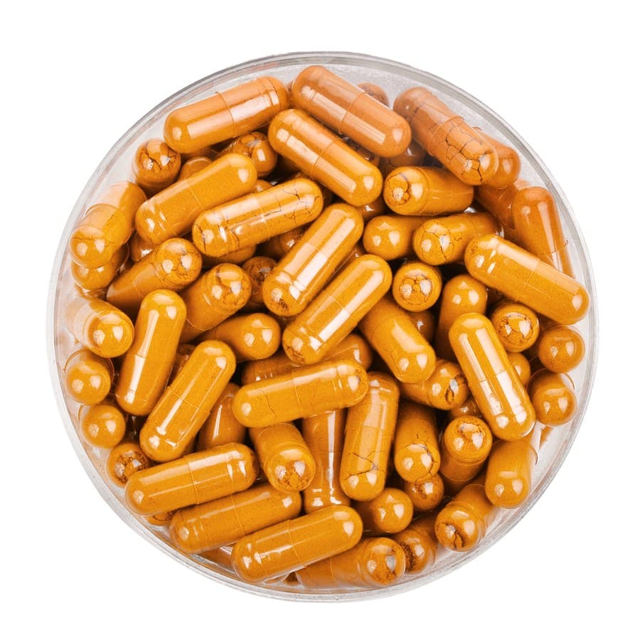 curcumin from turmeric in capsules in plastic cup