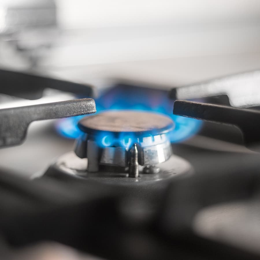 Lit gas burner on a kitchen stove
