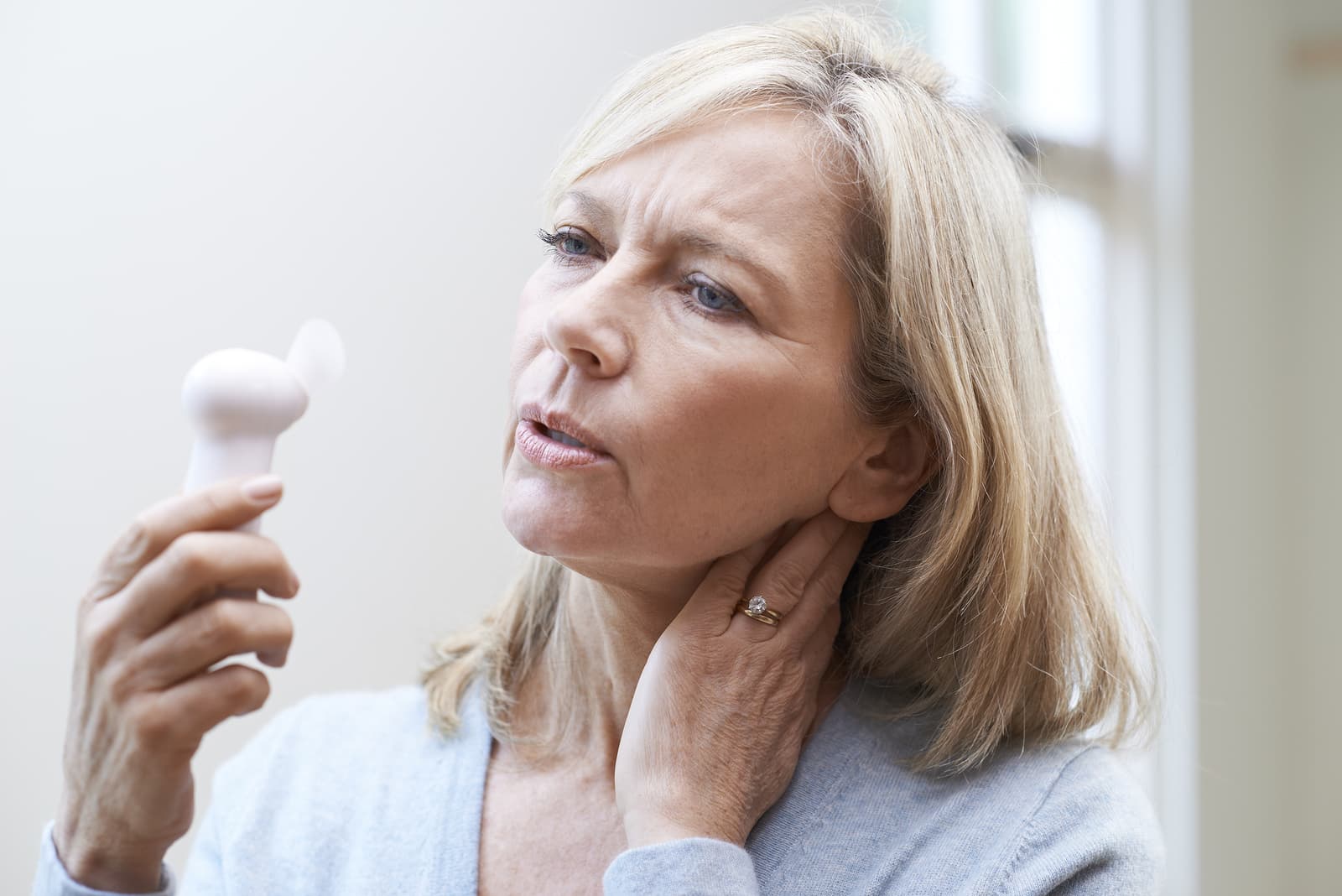 Mature Woman Experiencing Hot Flush From Menopause
