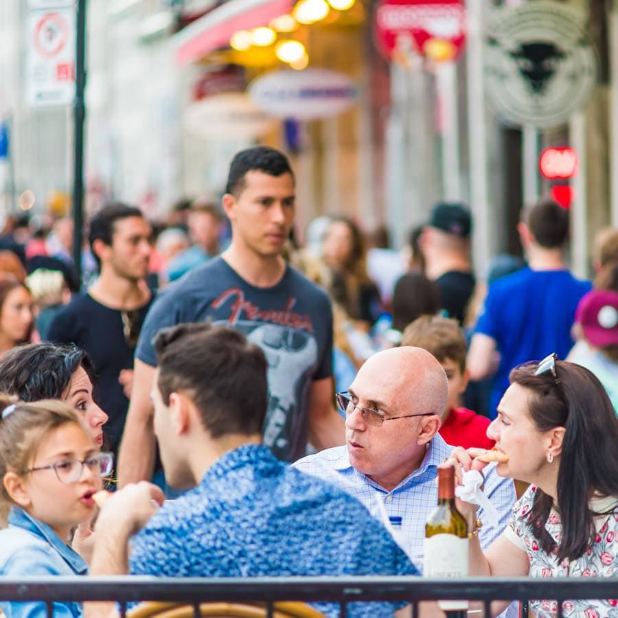 Montreal Canada &#8211; May 27 2017: Old town area with people sitting eating food and enjoying atmosphere in evening outside restaurant in Quebec region city
