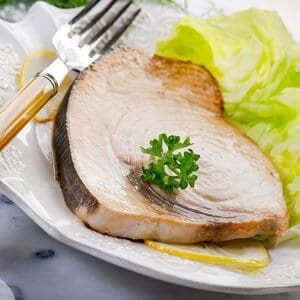 cooked swordfish steak with greens