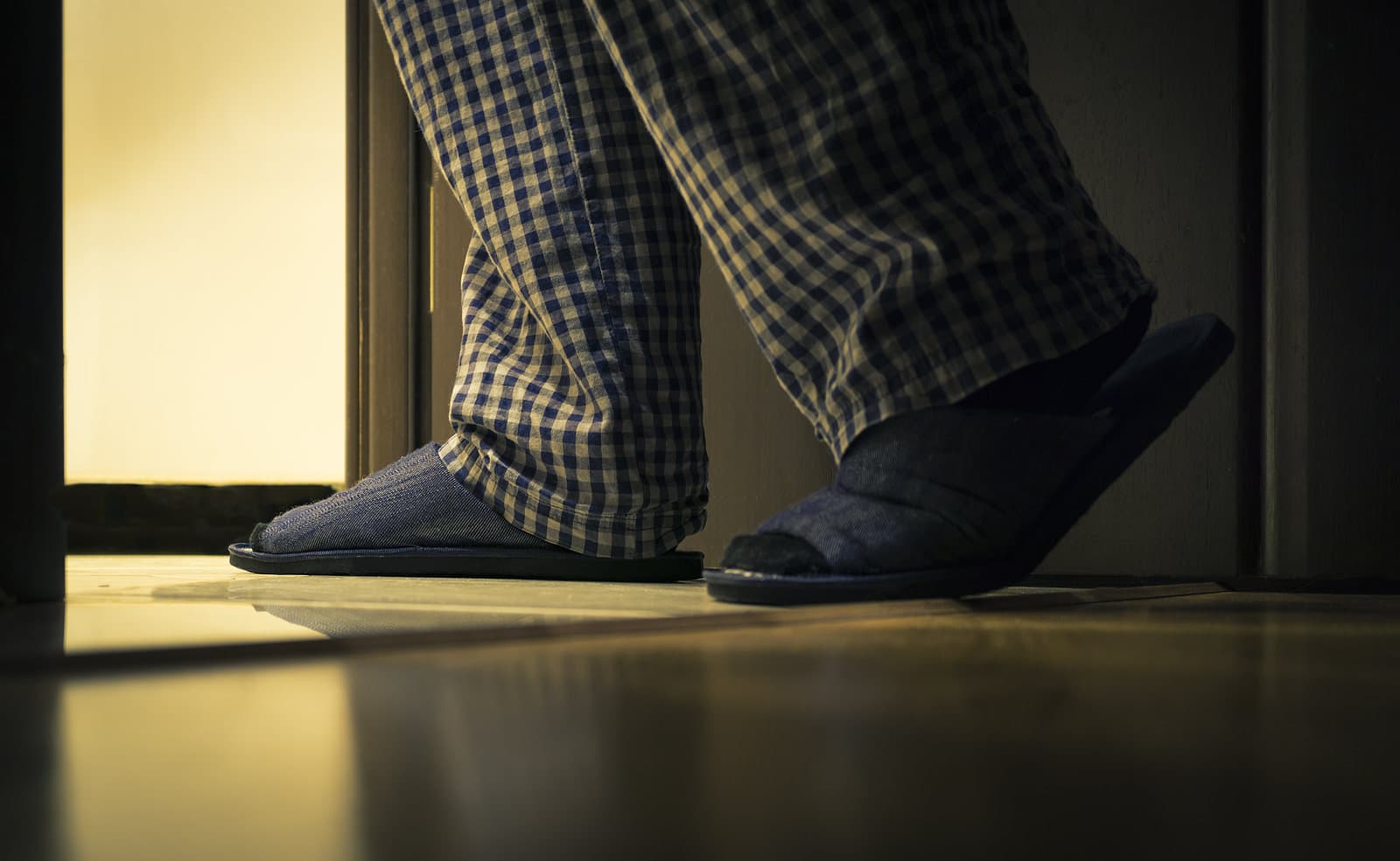man in plaid pajamas has to get up to pee