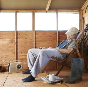 Man sitting in deckchair falling asleep in the shed sleepy insomnia
