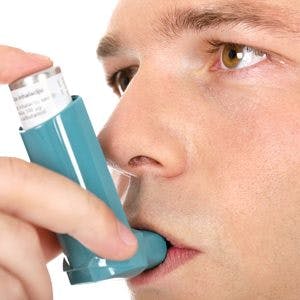 man using an asthma inhaler