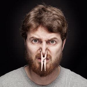 man with a clothespin on his nose