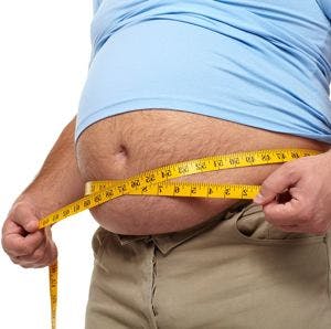 man measuring his fat belly bulge with a measuring tape