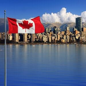 Canadian flag in front of the beautiful city of Vancouver, Canada.