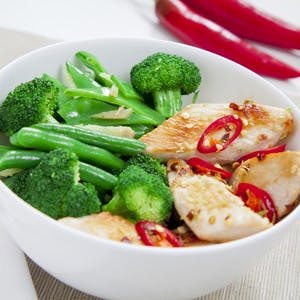 Grilled chilli chicken with steamed broccoli snow peas green beans and ginger
