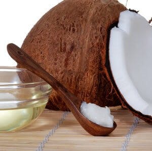 a coconut and coconut oil on a spoon