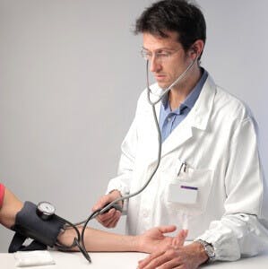 doctor taking blood pressure reading