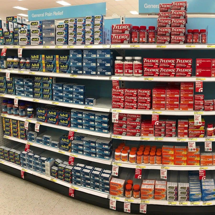 Drugstore shelves with over the counter (OTC drugs) pain relief products.