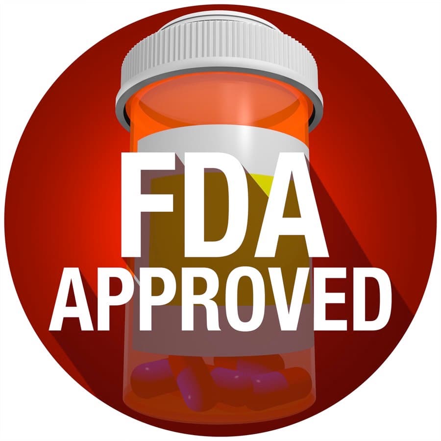 FDA Approved words on an orange pill or medicine bottle with long shadow
