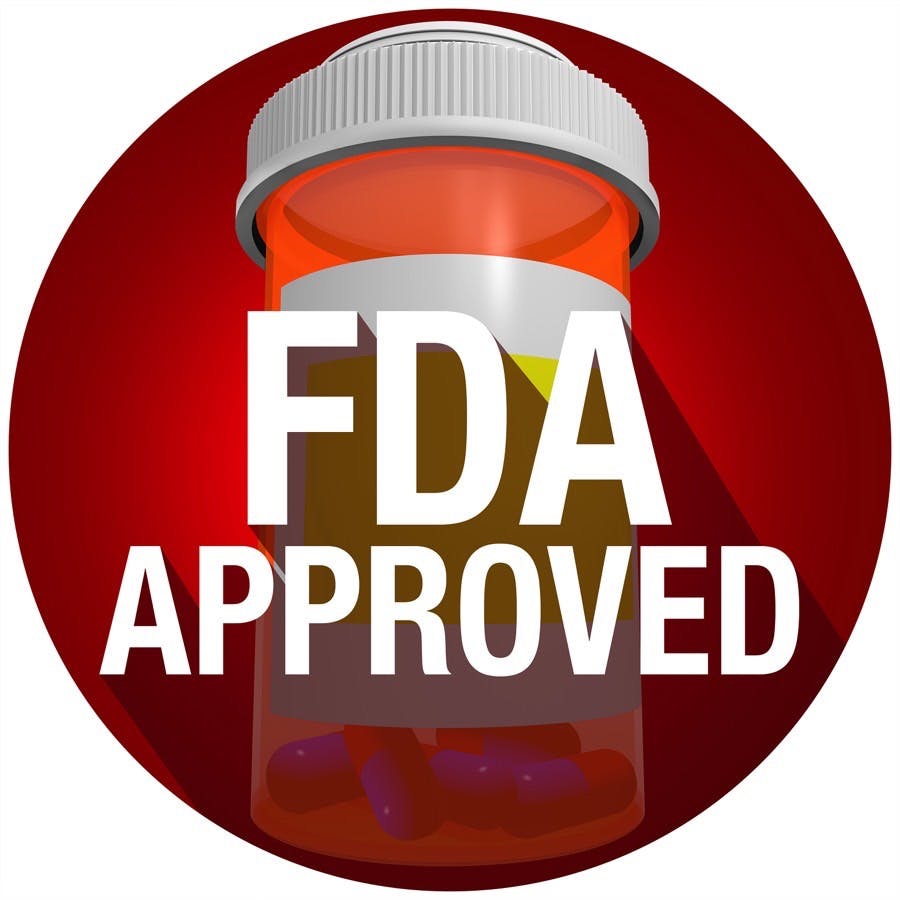 FDA Approved words on an orange pill or medicine bottle with long shadow
