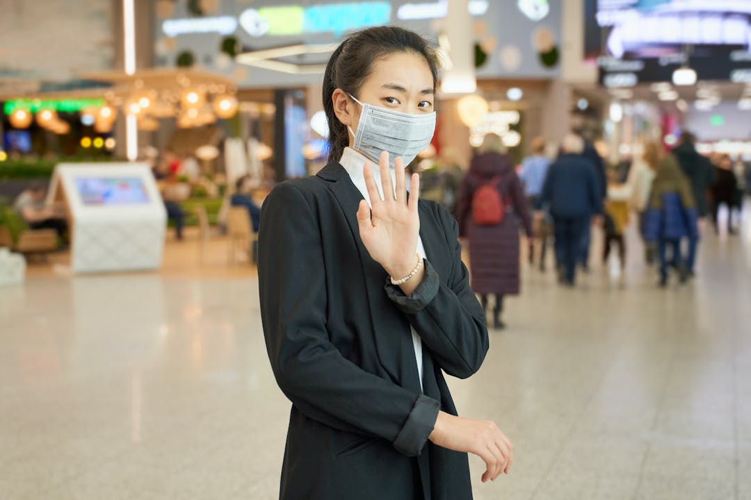 Female wears medical mask to protect against virus
