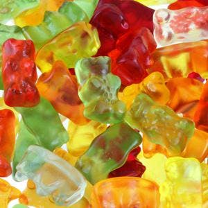 Background photo : Assortment of colorful fruity Gummy Bears
