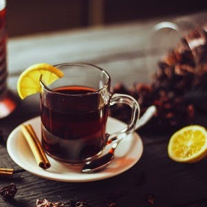 Cup of hibiscus tea with lemon and cinnamon