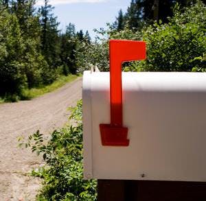 a mailbox on a country road on a sunny day