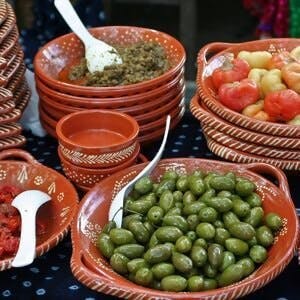 Mediterranean snack on ceramics dishes in market
