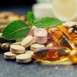 Pills and multivitamins on a dark background closeup

