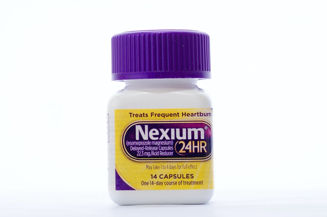 LLANO TX-AUG 16 2015: Bottle of Nexium against white background. The &#8220;Purple Pill&#8221; now sold in &#8220;Non-Prescription&#8221; size dosage.

