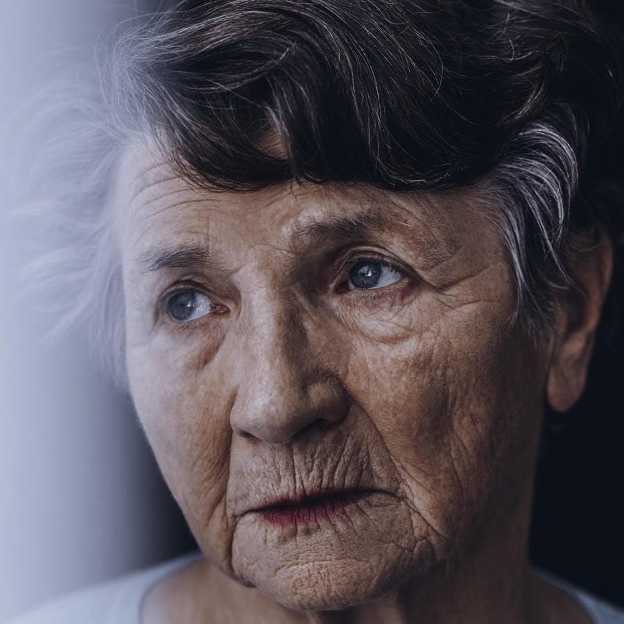 Close-up of worried lonely old woman&#8217;s face with wrinkles
