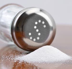 pile of salt next to a salt shaker