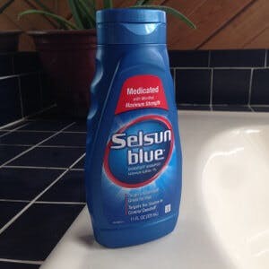 A bottle of Selsun Blue dandruff shampoo
