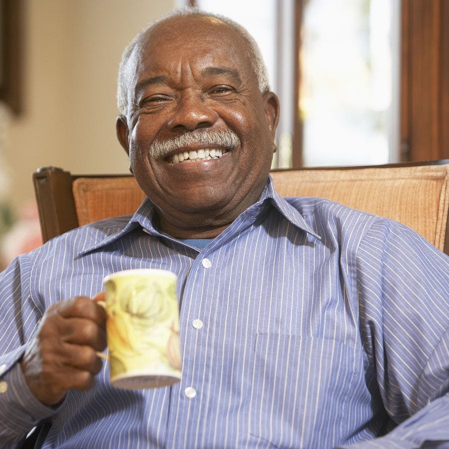 Older African American man drinking coffee from a mug