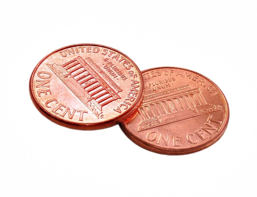This is a picture of two shiny pennies  isolated over white
