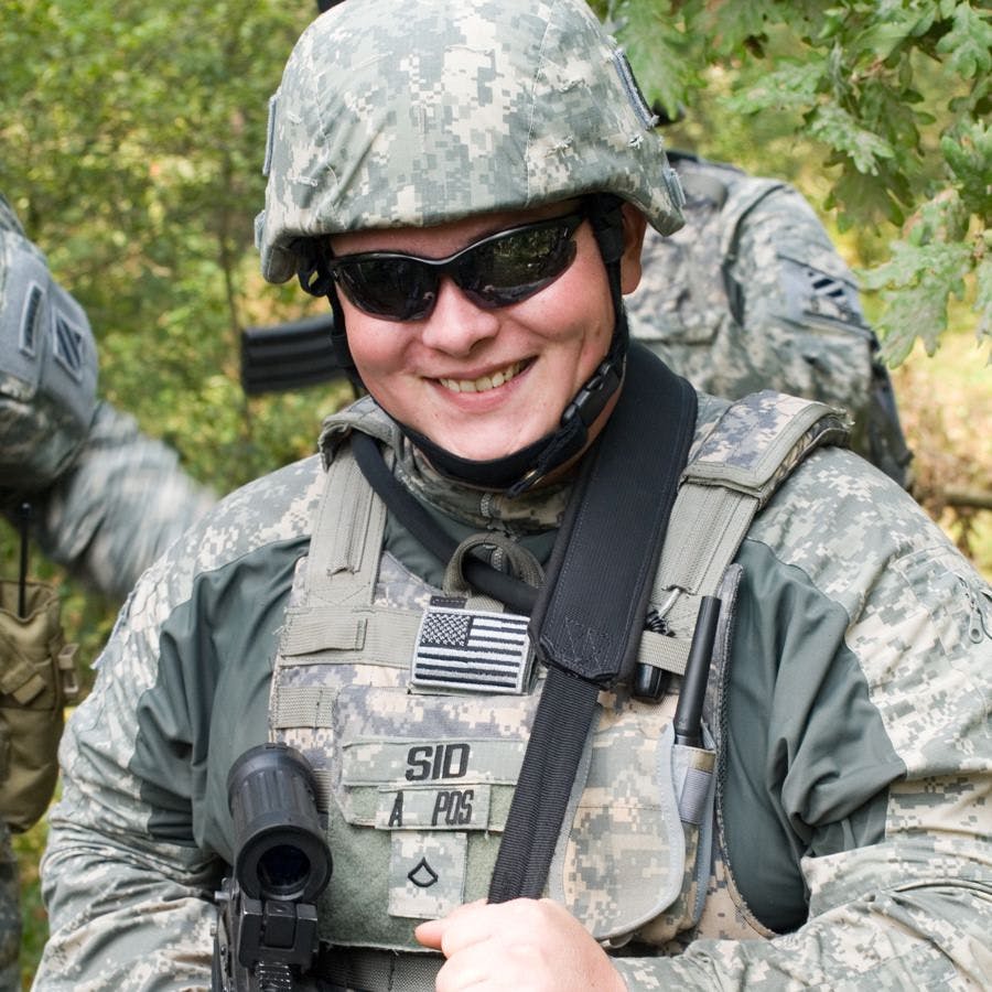 The portrait of the smiling US Army soldier with machine gun
