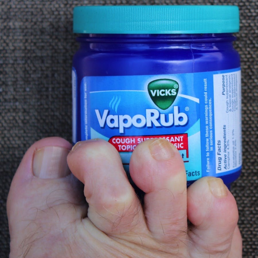 A bottle of vicks vaporub and toes
