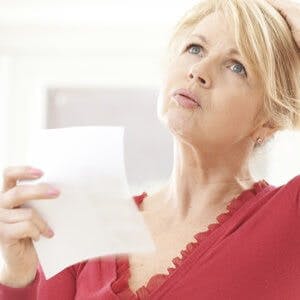 Mature Woman Experiencing Hot Flush From Menopause
