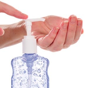Woman Pumping Gel Hand Sanitizer From A Bottle, Concept For Swine Flu H1-N1
