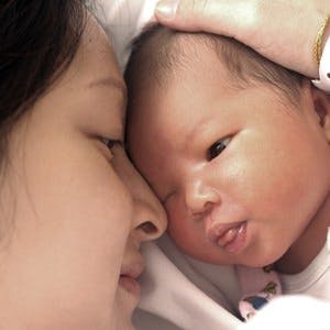 Asian mother and her cute newborn baby
