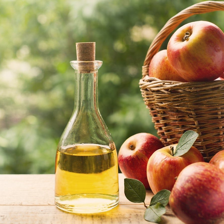 Apple cider vinegar in bottle with apple summer day
