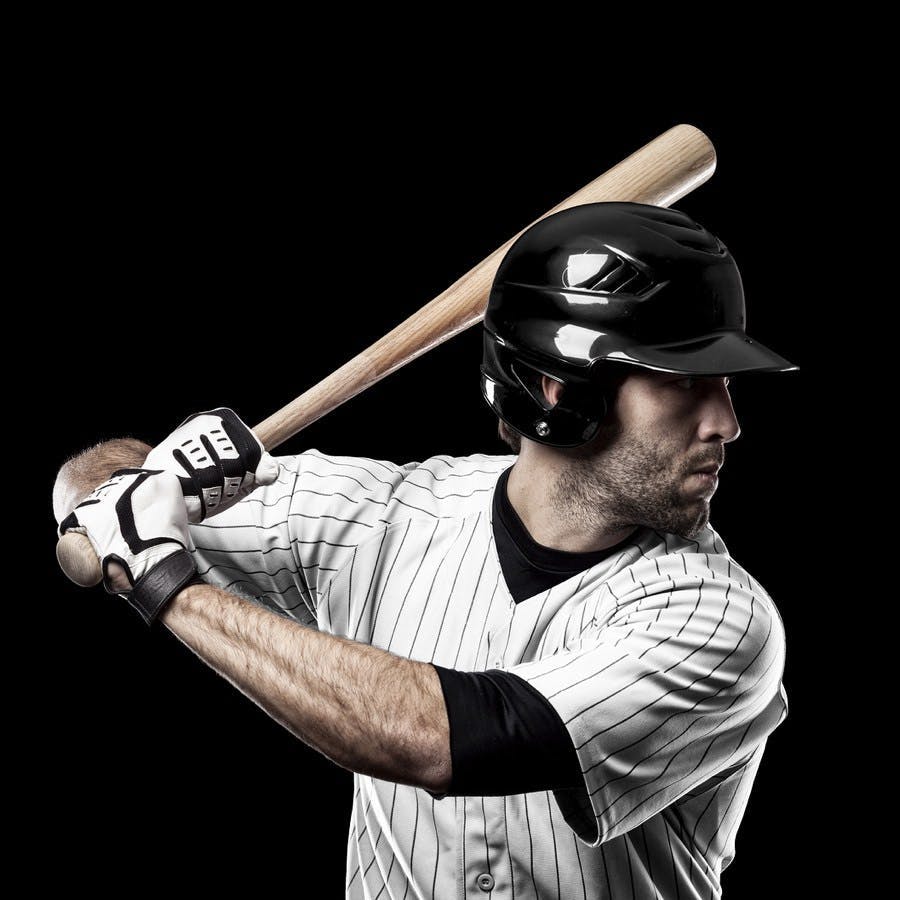 Baseball Player with a white uniform on a black background.
