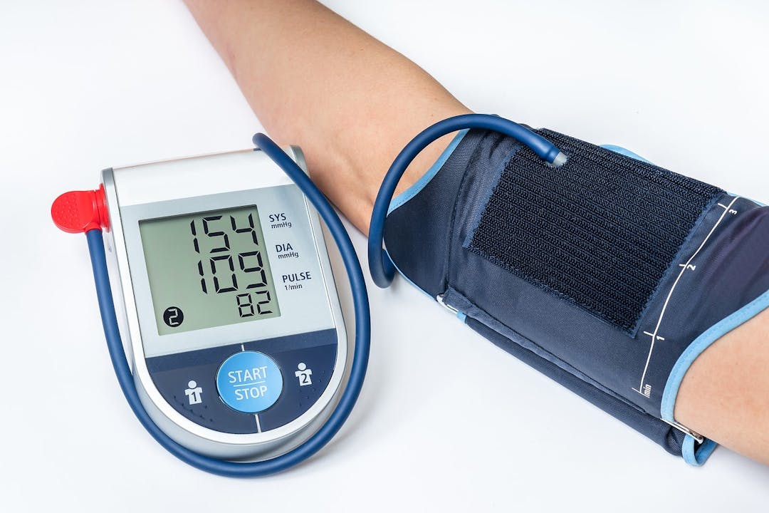 Blood pressure monitor with high pressure level on screen &#8211; hypertension concept
