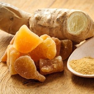 Three kinds of ginger &#8211; ground spice fresh and candied on rustic table. Healthy eating home remedy for nausea upset stomach colds.
